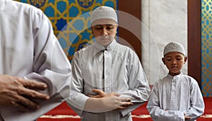 Muslim man and muslim kid praying