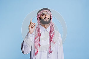 Muslim man pointing upwards with finger