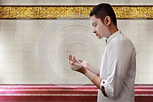 Muslim man praying inside mosque