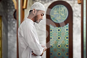 Muslim man praying inside mosque