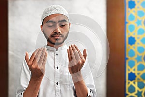 Muslim man praying inside mosque