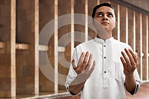 Muslim man praying inside mosque