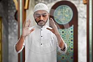 Muslim man praying inside mosque