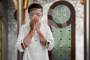 Muslim man praying inside mosque