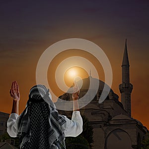 Muslim man praying near mosque