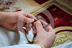 Muslim man praying with prayer-beads