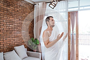 Muslim man praying wearing ihram clothes