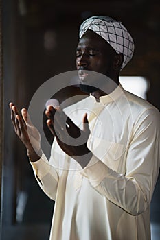 Muslim man praying and worship dua ask allah for blessing during ramadan photo