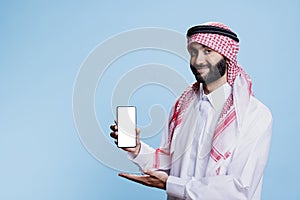 Muslim man presenting smartphone screen