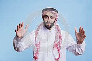 Muslim man raising hands and speaking