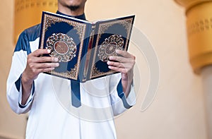 Muslim man reading holy Quran. Islamic concept