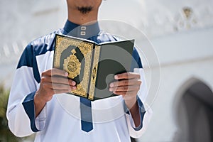 Muslim man reading holy Quran. Islamic concept