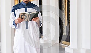 Muslim man reading holy Quran. Islamic concept