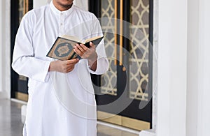 Muslim man reading holy Quran. Islamic concept