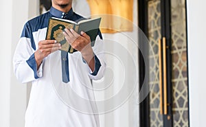 Muslim man reading holy Quran. Islamic concept