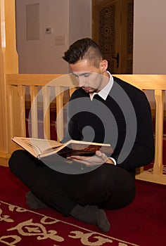 Muslim man reading Koran