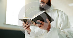 Muslim man, reciting and mosque for reading quran with faith, idea or culture for worship, praise or study. Islamic