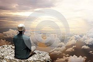 Muslim man sit on top mountain