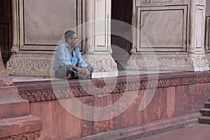 Muslim man sitting at Jama Masjid in Delhi, India