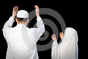 Muslim man standing and praying in the front of Kaaba in Mecca