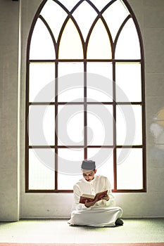 Muslim man studying The Quran