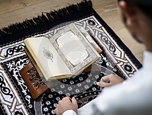 Muslim man studying The Quran