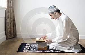 Muslim man studying The Quran