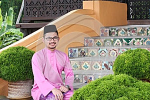 A muslim man with traditional baju melayu