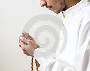 Muslim man using misbaha to keep track of counting in tasbih photo