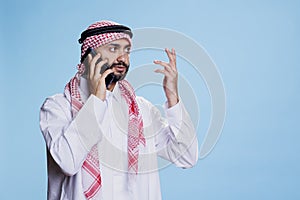 Muslim man speaking on smartphone