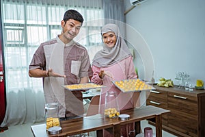 muslim man and woman bake nastar snack for idul fitri