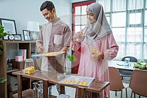 muslim man and woman bake nastar snack for idul fitri