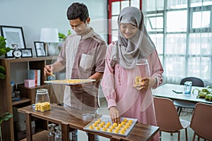 muslim man and woman bake nastar snack for idul fitri