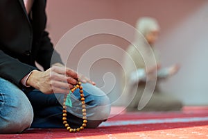 Muslim man and woman praying in mosque