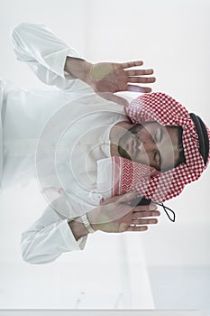 Muslim man doing sujud or sajdah on the glass floor