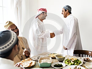 Muslim men shaking hands at lunchtime