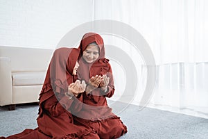 Muslim mother and daughter praying together