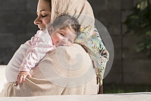 Muslim mother embraced a newborn baby photo