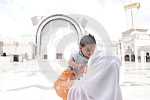 Muslim mother and her son together at a mosque