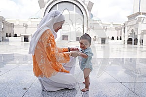 Muslim mother and her son together at a mosque