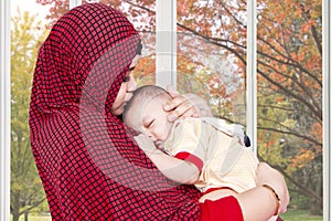 Muslim mother lull her baby at home