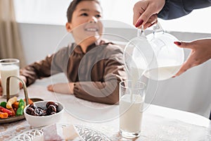 Muslim mother pouring milk during suhur photo