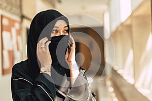 Muslim niqab woman Arab saudi girl closeup close face with black chador photo