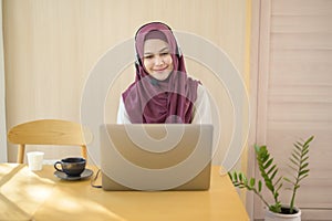 Muslim operator woman in headset using computer answering customer call in office, Customer service concept