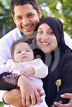 Muslim, park and portrait of parents with baby for bonding, ramadan and outdoors together. Islam, happy family and
