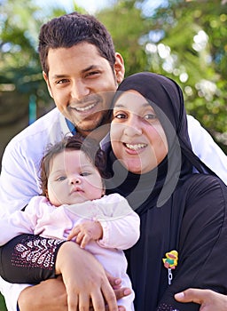 Muslim, park and portrait of parents with child for bonding, ramadan and outdoors together. Islam, happy family and