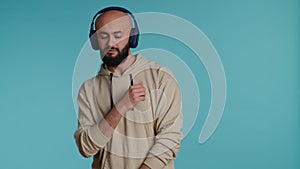 Muslim person listening to happy tunes on headphones