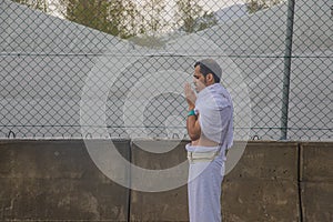 Muslim pilgrims praying on jabal Arafat, HajjHajj pilgrim prayingMuslim man wearing hajj cloth, Mecca, Saudi Arabia, August 10,