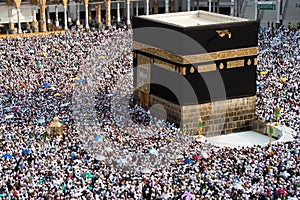 Muslim pilgrims revolving around the Kaaba in Mecca Saudi Arabia. Muslim people praying together at holy place. photo