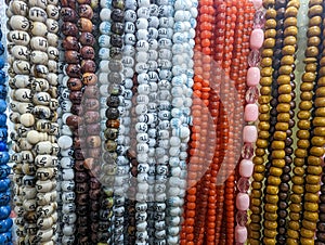 Muslim prayer chaplet market close up shot. Colorful plastic rosaries close up shot in the market. Religious beads with colorful